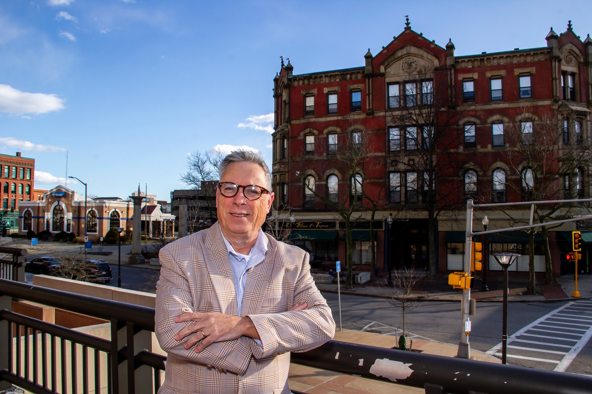 Carlos Cesar - Mayoral candidate standing confidently in downtown Fall River with historic buildings in background